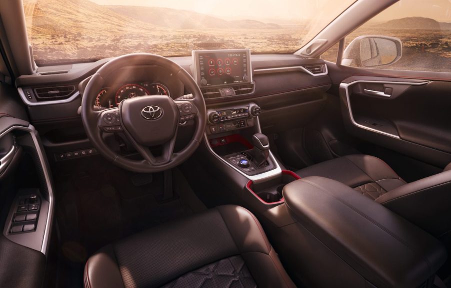 The black-and-red cockpit of a 2021 Toyota RAV4 TRD Off-Road compact crossover SUV