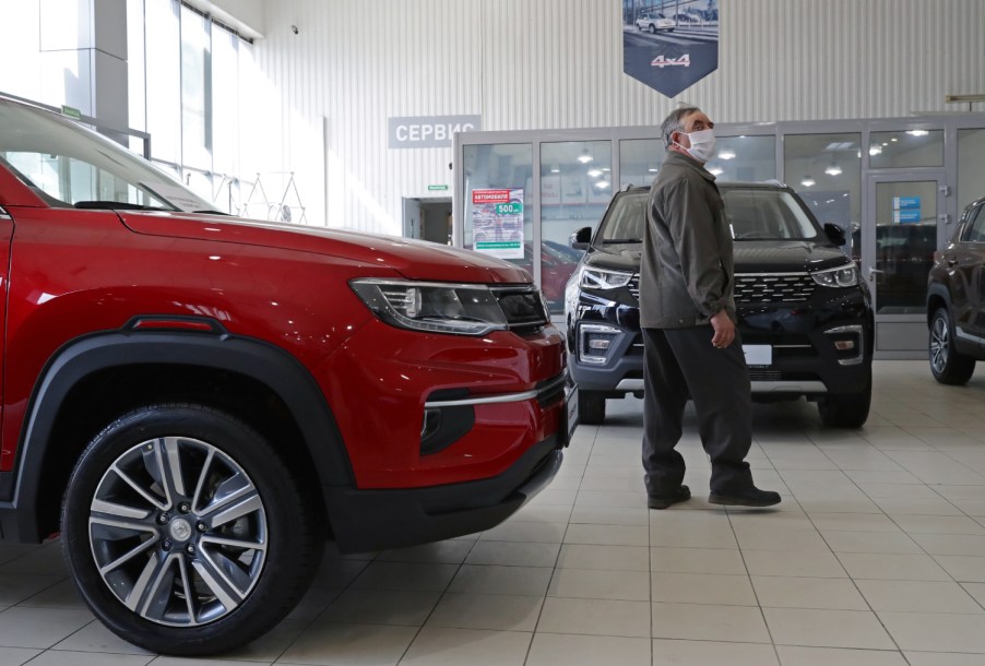 A potential customer browses cars at a car dealership