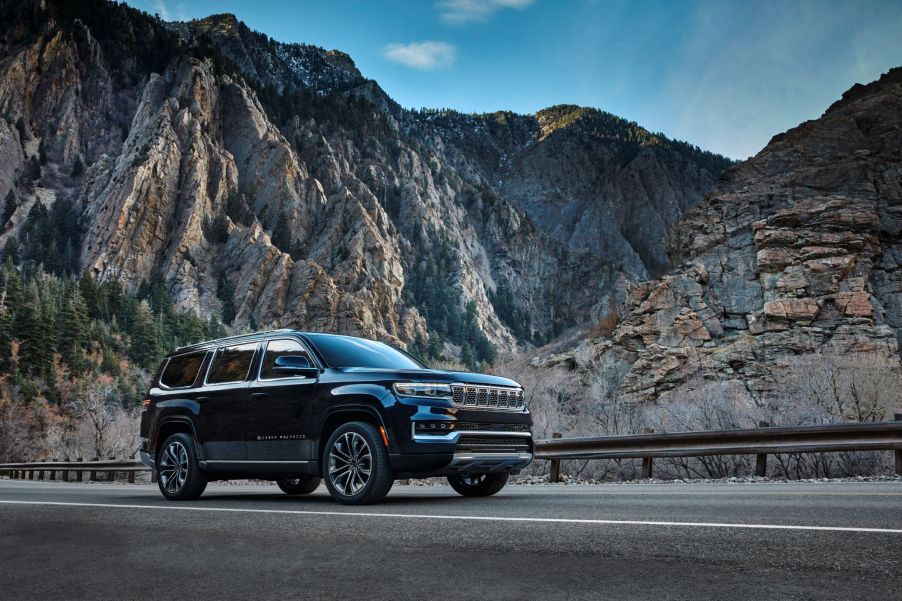 A black 2022 Jeep Grand Wagoneer Series III parked on a road in the mountains