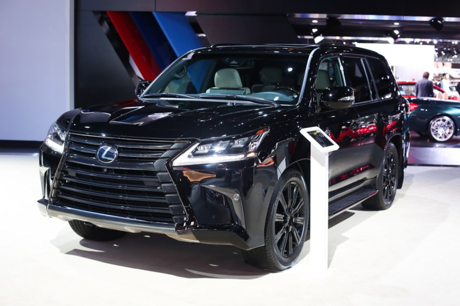 A black Lexus LX on display at an auto show