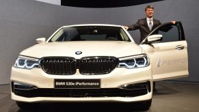 A BMW employee poses next to a 530e