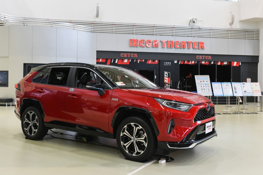 A red RAV4 plug-in hybrid Toyota SUV sits on display