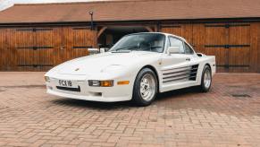 An image of a white Porsche 911 Turbo parked outdoors.