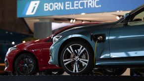 A pair of BMW 3 Series charging in a BMW showroom