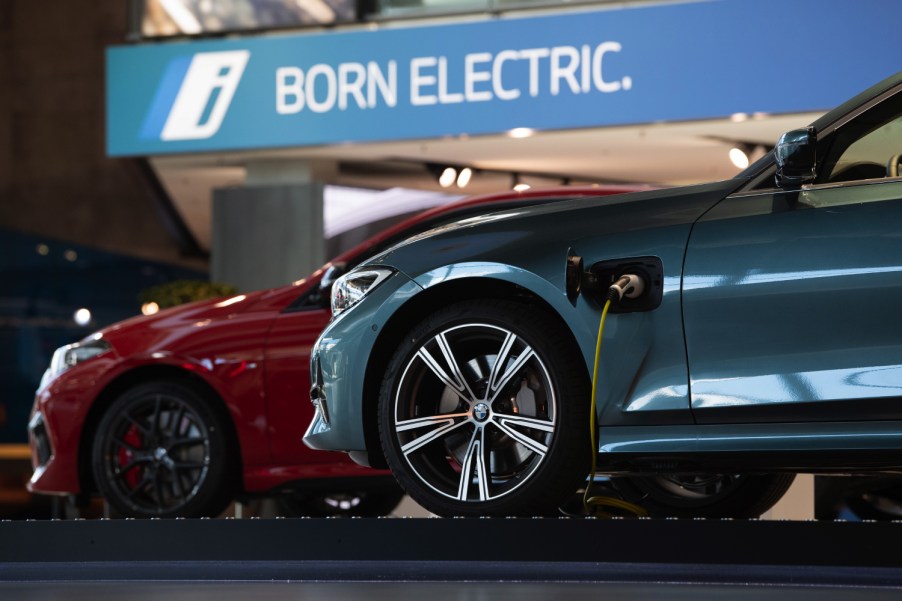 A pair of BMW 3 Series charging in a BMW showroom