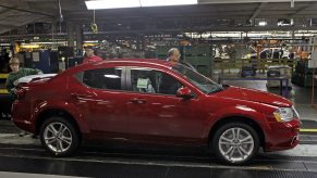 Workers inspect the 2011 Dodge Avenger at Chrysler Group's production plant in Sterling Heights, Michigan