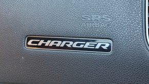 Close-up of the Dodge Charger logo on a car dashboard