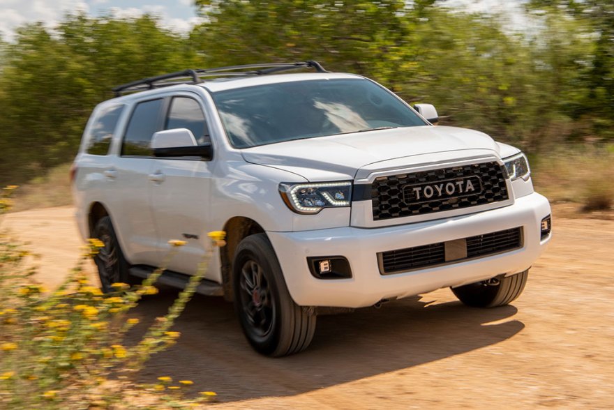 a white 2021 Sequoia driving on a dirt road