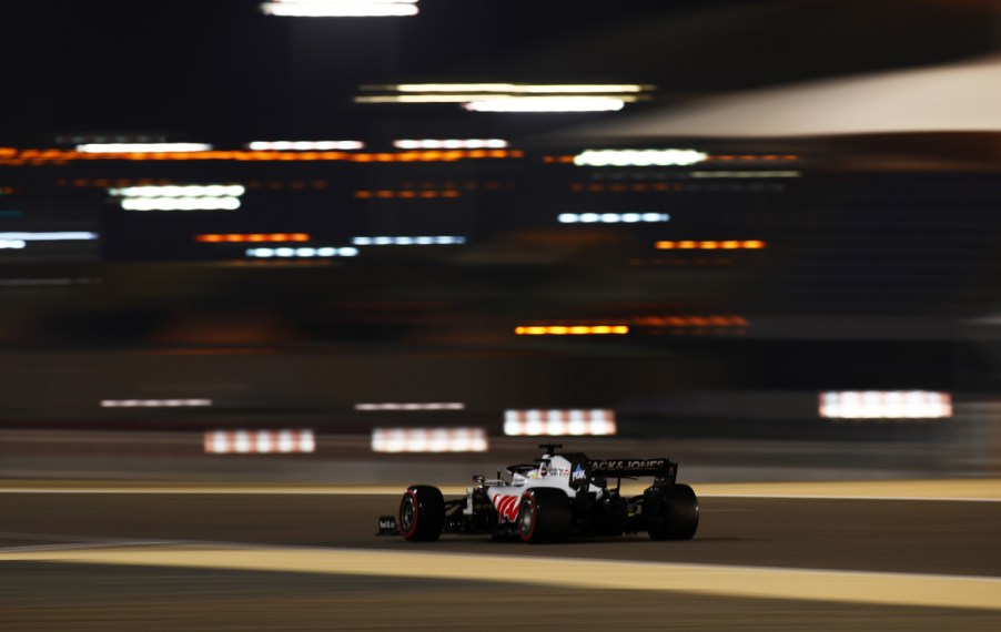 A Formula 1 Haas F1 Team race car moves down the track at a high rate of speed