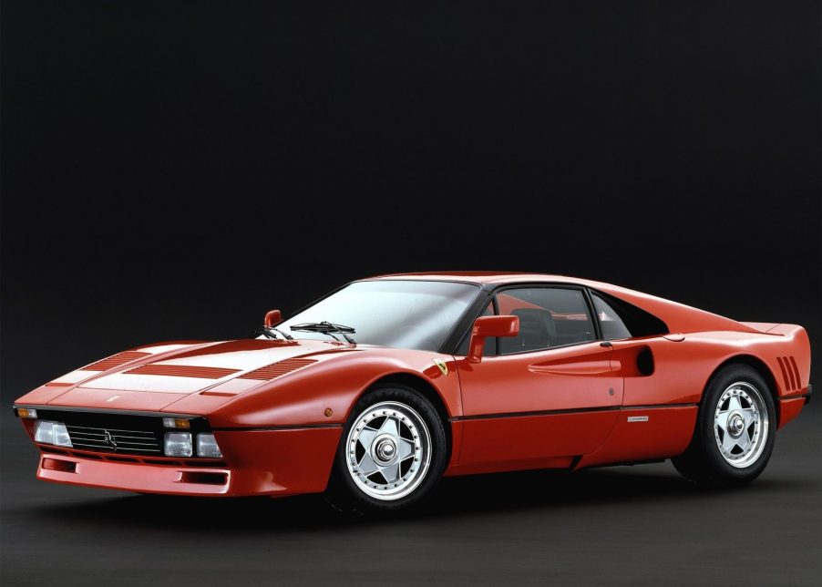 An image of a Ferrari 288 GTO parked inside of a studio.