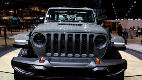 The front grille of a Jeep Gladiator on display at an auto show