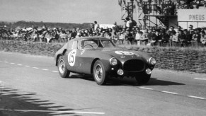 A black and white image of a Ferrari 375 MM out on a track.