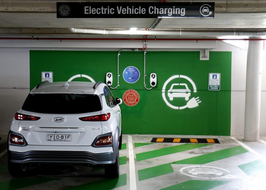 A white Hyundai KONA Electric charges at a EV charge station in Crows Nest