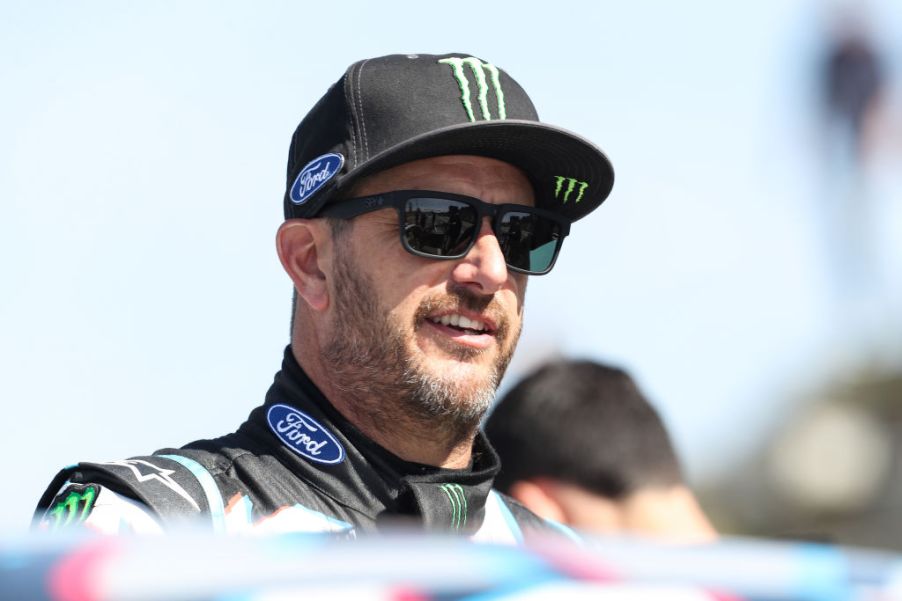 U.S. driver Ken Block standing in the sun wearing a ball cap and sunglasses