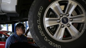 A mechanic performing an oil change.