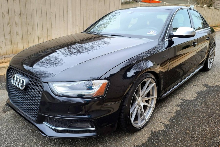 A black modified 2014 Audi S4 in a driveway