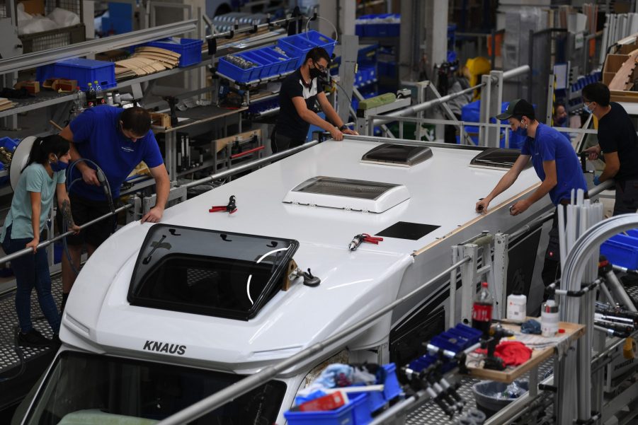 Employees fit the roof to a motorhome RV on the Knaus Tabbert AG assembly line