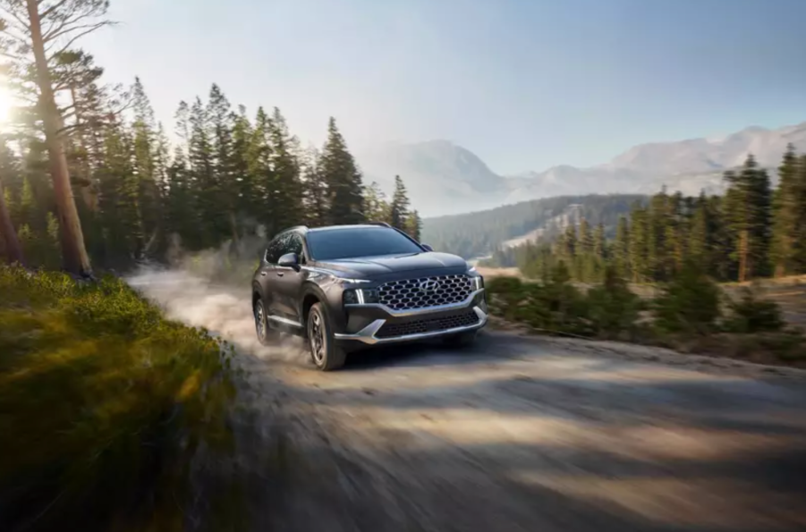 The 2021 Hyundai Santa Fe Hybrid driving on a dirt road