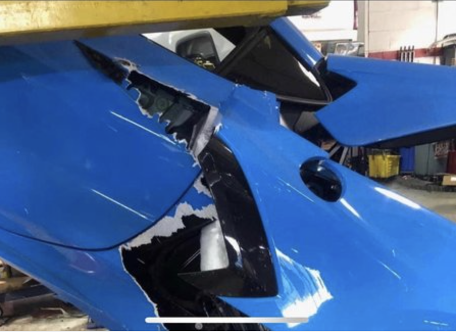 An image of a 2021 Chevrolet Corvette that fell from a mechanic's lift.