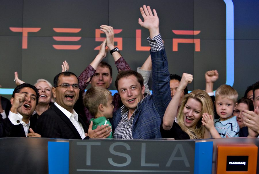 Elon Musk and some Tesla employees ring the bell at the stock exchange