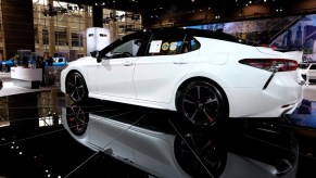 A white Toyota Avalon on display at an auto show