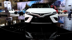 A white Toyota Avalon on display at an auto show