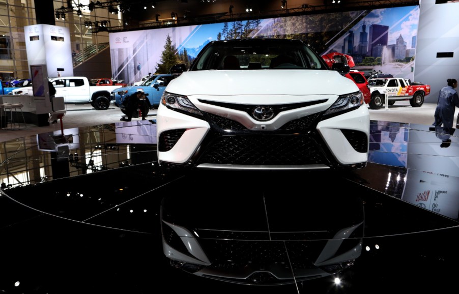 A white Toyota Avalon on display at an auto show