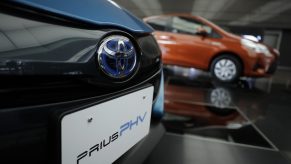 A Toyota Motor Corp. badge is displayed on a Prius plug-in hybrid vehicle (PHV), known as Prius Prime in the U.S., at the company's head office in Tokyo