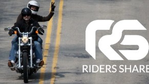 Two riders ride a rented cruiser down the road