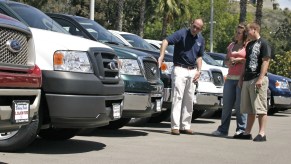 A group of Ford trucks for sale on a car lot