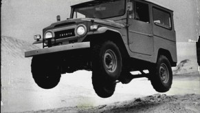 A 1970 Toyota Land Cruiser jumping sand hills