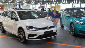 A man wipes down a Volkswagen Golf