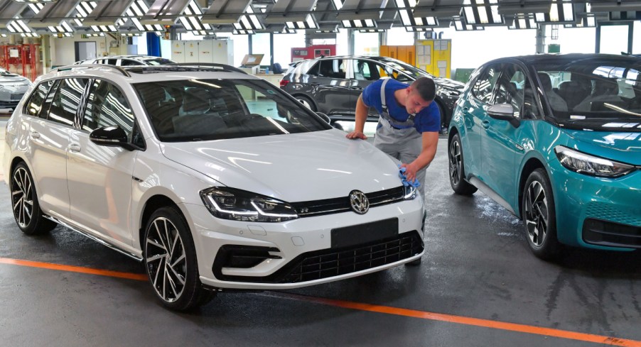 A man wipes down a Volkswagen Golf