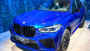 A blue BMW X5 M on display