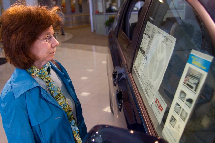 A customer inspects the window sticker of a 2011 Toyota Sienna at Fred Anderson Toyota in Raleigh, North Carolina