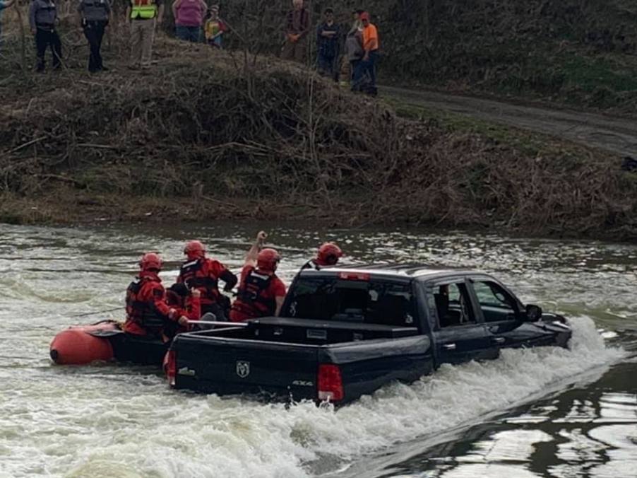 Family being rescued from Ram 1500 Classic in floodwater