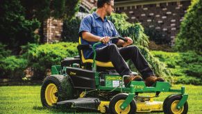 A man using a 2021 John Deere Z365R Zero Turn Mower