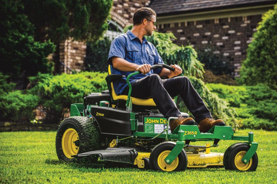 A man using a 2021 John Deere Z365R Zero Turn Mower