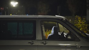 shadowy figure appearing to steal a car. Maybe in a stolen car