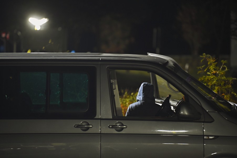 shadowy figure appearing to steal a car. Maybe in a stolen car