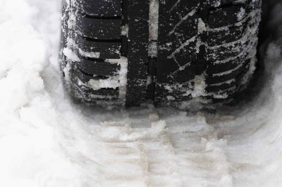 A close up of a tire in the snow