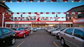 Cars parked in front of a used car dealership