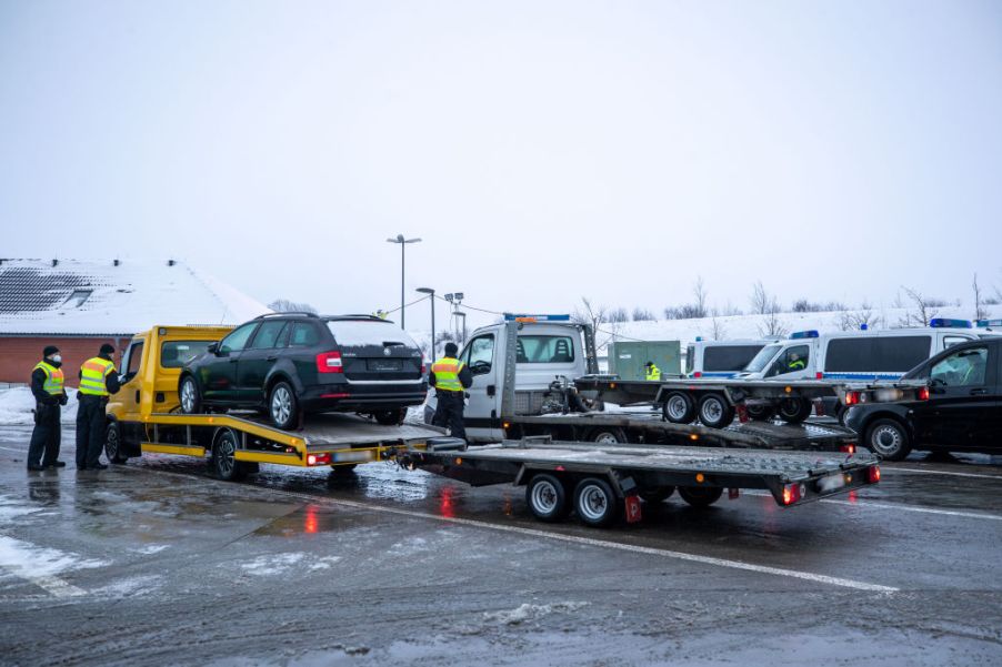 Vehicles being loaded onto tow trucks