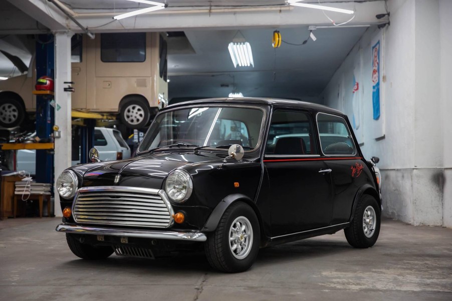 A black 1988 Rover Mini Jet Black Edition in a car workshop garage