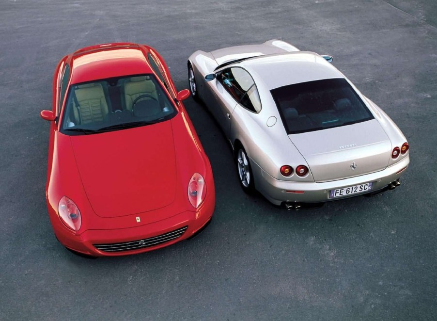 A front-facing red 2004 Ferrari 612 Scaglietti parked next to a rear-facing silver one