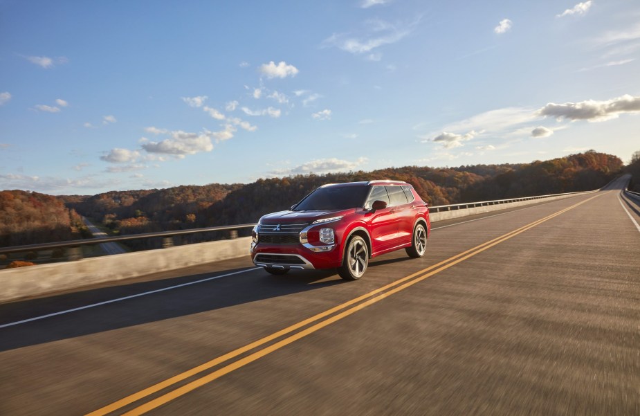 The 2022 Mitsubishi Outlander in red driving down the road. Consumer Reports is currently testing this model