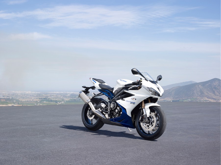 A white-and-blue 2016 Triumph Daytona 675 on a mountainside parking lot