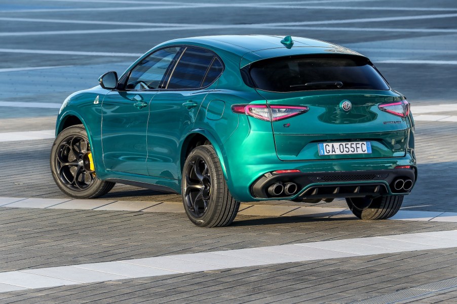 A teal metallic 2021 Alfa Romeo Stelvio Quadrifoglio luxury compact SUV parked on bricks