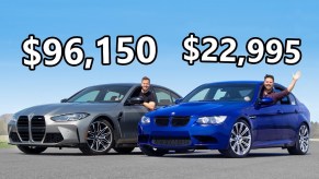 A silver 2021 BMW M3 next to a blue 2008 E90 BMW M3 on a racetrack