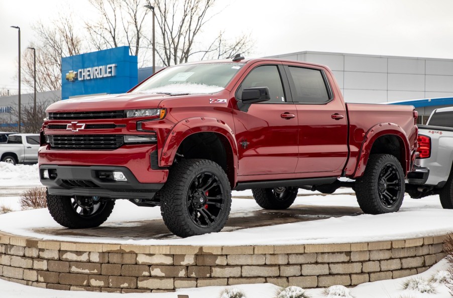 Pictured is a red 2021 Chevy Silverado outdoors.